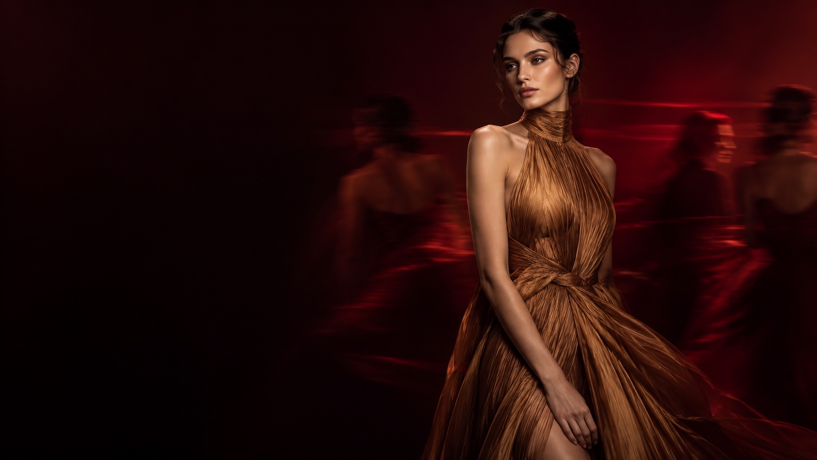 Fashion model in bronze pleated couture, still against a blurred burgundy scene